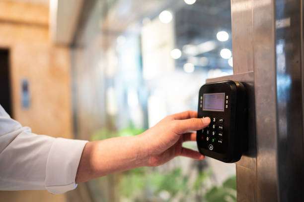 Unrecognizable Man entering code to  open door of office , close up to human hand and fingers